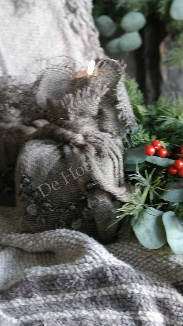Jute cadeau met ketting in sober bruinbeige, burlaptextuur, omringd door groen met rode bessen, De Hooyzolder